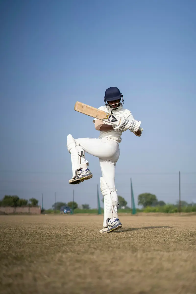 Batter in white cricket kit playing a shot